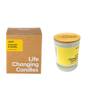Candle with wooden lid and 'Life Changing Candles' packaging on a white background