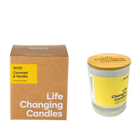 Candle with wooden lid and 'Life Changing Candles' packaging on a white background
