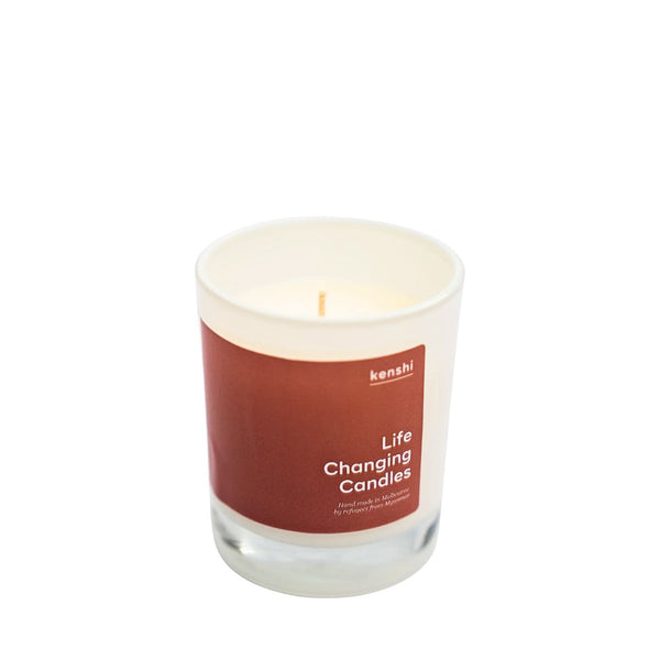 Candle with a brown label on a white background