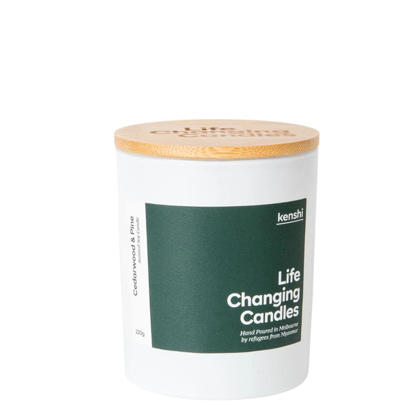 Candle with a wooden lid and green label on a white background