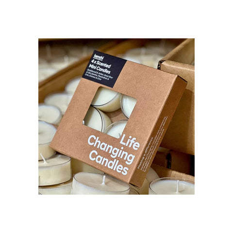 Box of 'Life Changing Candles' with tealight candles inside on a white background