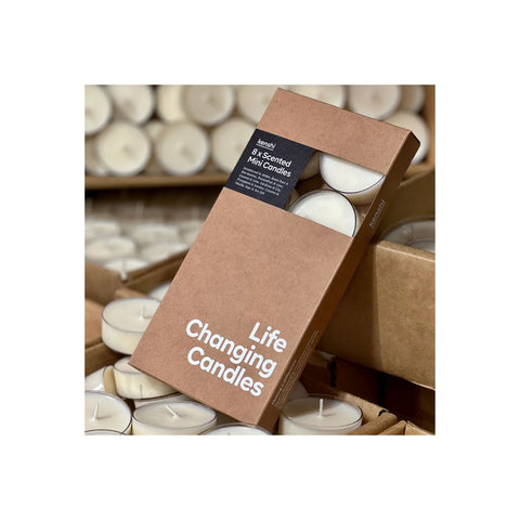 Box of 'Life Changing Candles' with candles in the background