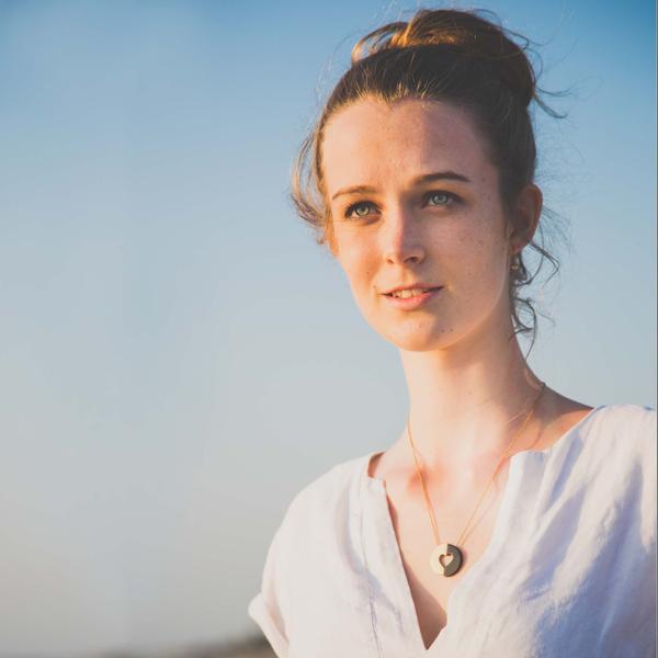 woman wearing half Gold and half black heart pendant on short gold chain - Commitment necklace from Eden - Shop Ethical Jewellery & Fair Trade Gifts Melbourne at ONLY JUST 