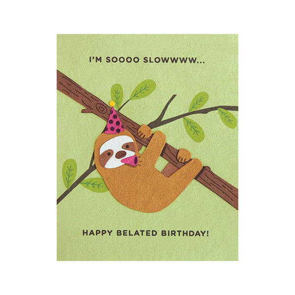 Fair Trade handmade green card depicting a sloth hanging from branch wearing party hat and blowing party blower. Message reads "I'm soooo slowwww... Happy belated birthday!"
