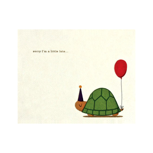 Fair Trade handmade cream card depicting a turtle with red balloon attached from tail and wearing party hat. Message reads "sorry I'm a little late..."