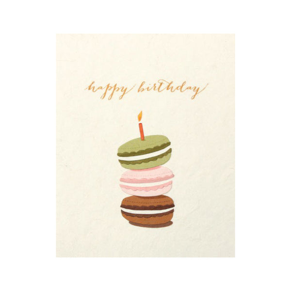 Fair Trade handmade card depicting 3 macarons (chocolate, pink and green) in a stach with one candle on top. Message reads "Happy birthday"