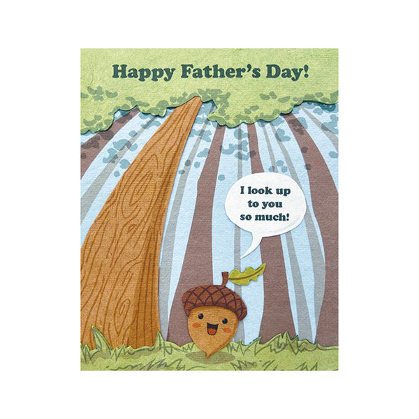 Fair Trade handmade card depicting an acorn on forest ground surrounded by tall trees, saying:"I look up to you so much". Main message reads "Happy Father's Day!"