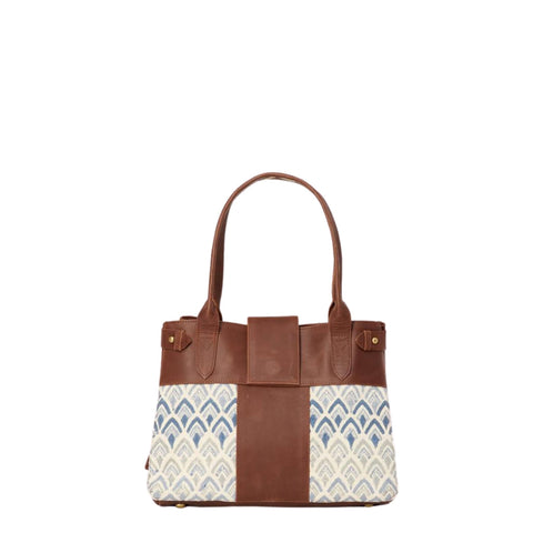 Handbag with hand-blockprinted cotton with blue print and brown leather exterior with paddle handles and expandable side straps