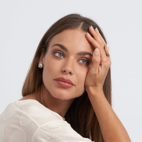 Model wearing round stud  earrings