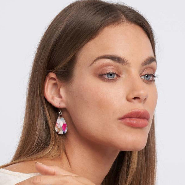 Model wearing teardrop shaped resin earring in mixed colours